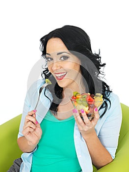 Attractive Young Heathy Woman Holding Up A Fresh Exotic Fruit Salad