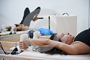 Attractive young lady doing pilates