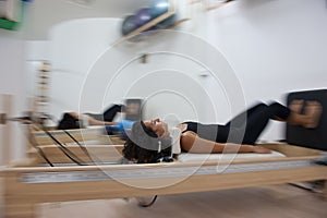 Attractive young lady doing pilates