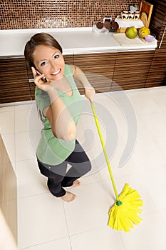 Attractive young lady taking a break from cleaning