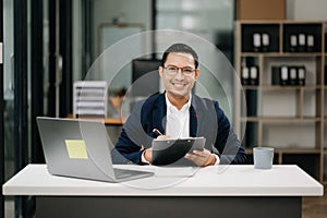 Attractive young lawyer in office Business man and lawyers discussing contract papers laptop and tablet with brass scale on desk