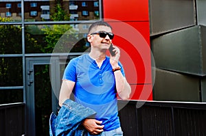 Attractive young male model texting on a smartphone