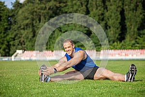 Attractive young male runner is exercising before