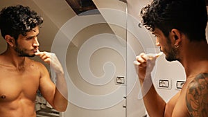 Attractive young man brushing teeth