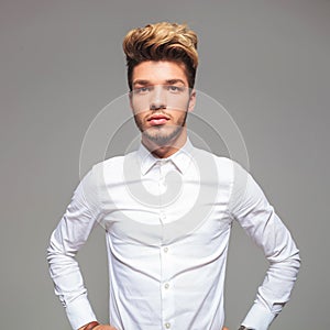 Attractive young man in casual shirt with hands on waist