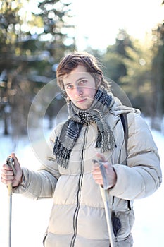 Attractive young man cross-country skiing