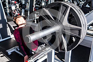 Attractive Young Man Doing Leg Press On Machine In Gym in a day time