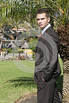 attractive young man in elegant clothes outdoors