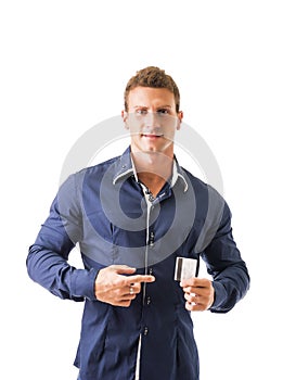 Attractive young man holding credit card, looking