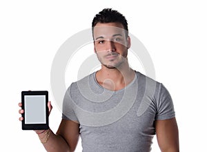 Attractive young man holding and showing ebook reader