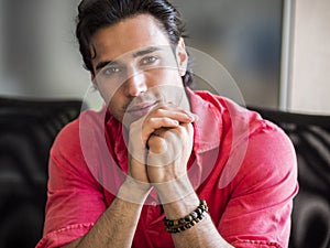 Attractive young man indoors wearing a shirt