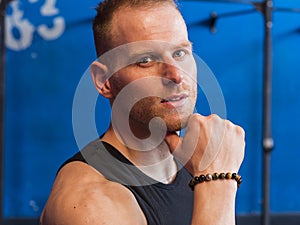 Attractive young man indoors wearing a tanktop