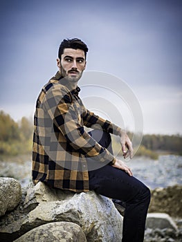 Attractive young man on a lake in a sunny