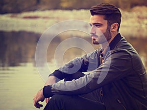 Attractive young man on a lake in a sunny