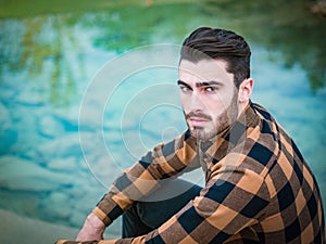 Attractive young man on a lake in a sunny