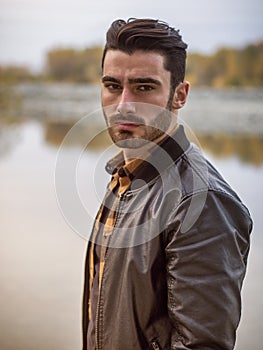 Attractive young man on a lake in a sunny