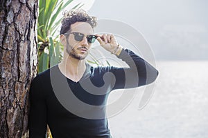 Attractive young man on a lake in a sunny day