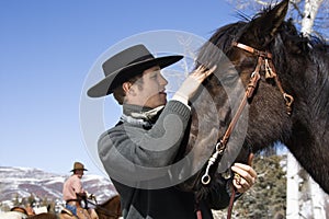 Attractive Young Man Petting Horse photo