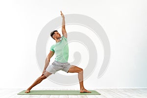 Attractive Young Man practicing advanced yoga on white background. A series of yoga poses. for good health. Sport