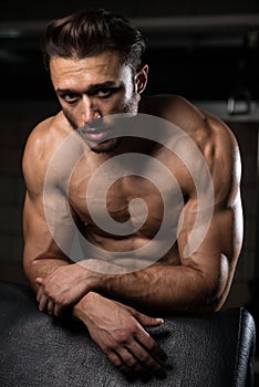 Attractive Young Man Resting In Gym Afther Exercise