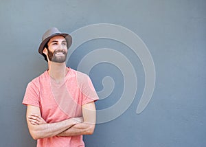 Attractive young man smiling with arms crossed