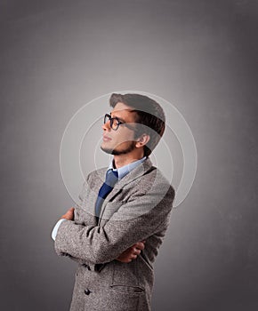 Attractive young man standing and thinking with copy space