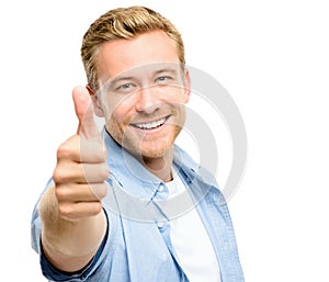 Attractive young man thumbs up full length on white background