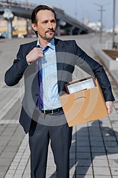 Attractive young man touching his tie