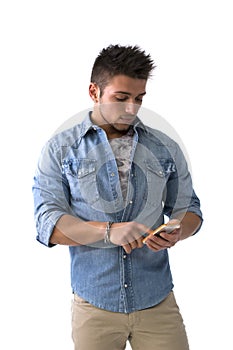 Attractive young man typing on smartphone, sending text message