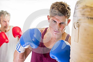 Attractive young man using a punching bag