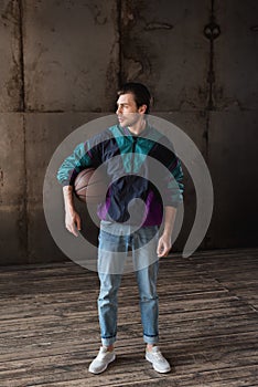 attractive young man in vintage windcheater with basketball ball photo