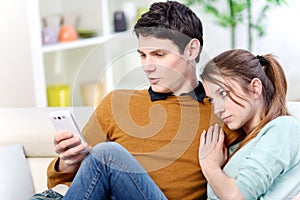 Attractive young man watching a screen of cell