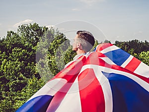 Attractive, young man waving a British Flag