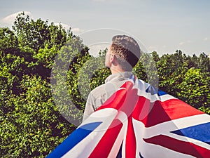 Attractive, young man waving a British Flag