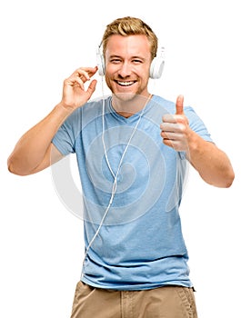 Attractive young man wearing headphones on white background