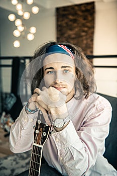 Attractive young musician wearing light shirt and colorful bandana