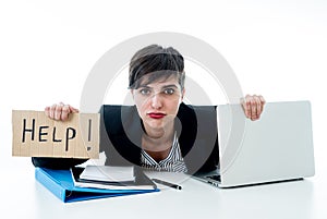 Attractive young overwhelmed and frustrated business woman working on her computer asking for help