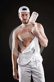 attractive young painter with paint roller