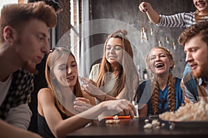 Attractive young people throwing popcorn and enjoying together.