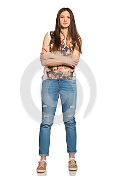 Attractive young relaxed woman, full height, with crossed arms