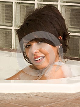 Attractive young female taking bath