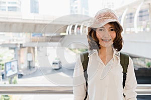 Attractive young smiling Asian woman outdoors portrait in the city real people series. Outdoors lifestyle fashion portrait of
