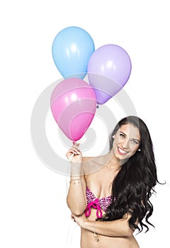 Attractive Young Smiling Brunette holding Colorful Balloons