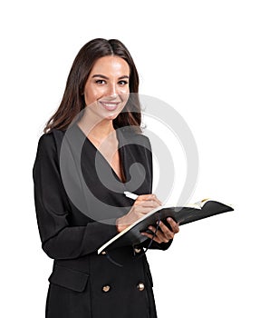 Attractive young smiling businesswoman in formal black jacket suit is holding a notebook and taking notes. Woman in business