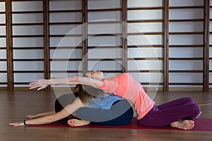 Attractive young sport girls are doing yoga together. Group training