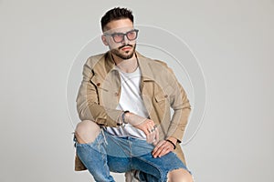 Attractive young unshaved man in jacket looking away