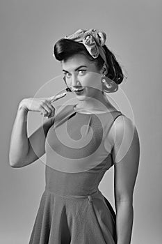 Attractive young woman in 50s style with perfect make-up and ha