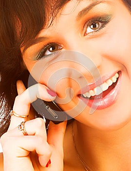 Attractive young woman calling by cellular phone. Isolated over