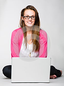 Attractive young woman celebrating with laptop