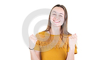 Attractive young woman clenching fists with happiness excited stunned Unbelievable surprise winning concept